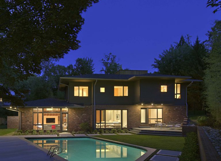 The landscape objectives for this unusual c. 1965 house included a welcoming entrance courtyard, privacy for the rear yard garden and pool area, and consideration for the drainage issues inherent to the property. The design, which evolved comprehensively along with the renovation of the house, evokes that of a Japanese garden. The inner court is a calm, peaceful space that belies the complexity of the project. The staggered concrete stepping pads, river stones, and low plantings can be seen from numerous rooms within the house, blurring the lines of where the garden begins and ends. At the rear, hand-cut stone was used for the terraces and pool coping while the pool deck is architectural concrete. A screen of Black Cane Bamboo (Phyllostachys nigra) and River Birch (Betula nigra) contribute to the contemplative planting scheme.
