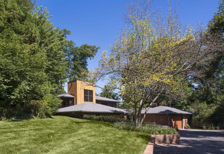 The landscape objectives for this unusual c. 1965 house included a welcoming entrance courtyard, privacy for the rear yard garden and pool area, and consideration for the drainage issues inherent to the property. The design, which evolved comprehensively along with the renovation of the house, evokes that of a Japanese garden. The inner court is a calm, peaceful space that belies the complexity of the project. The staggered concrete stepping pads, river stones, and low plantings can be seen from numerous rooms within the house, blurring the lines of where the garden begins and ends. At the rear, hand-cut stone was used for the terraces and pool coping while the pool deck is architectural concrete. A screen of Black Cane Bamboo (Phyllostachys nigra) and River Birch (Betula nigra) contribute to the contemplative planting scheme.